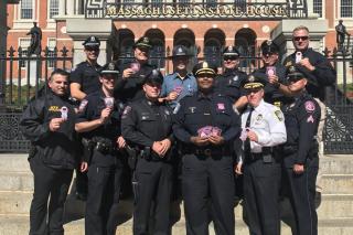 Officer Ryan Peterson at the MA State House in Boston with other MA Pink Patch Project partner agencies